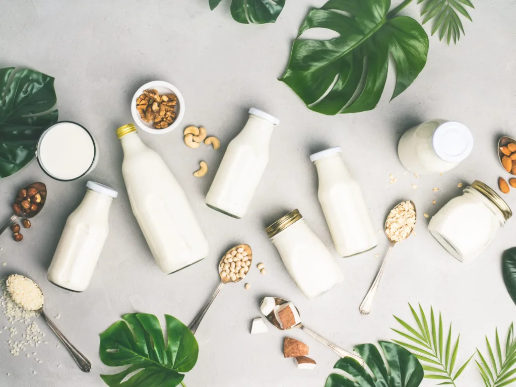 Variety of plant-based milk in glass bottles
