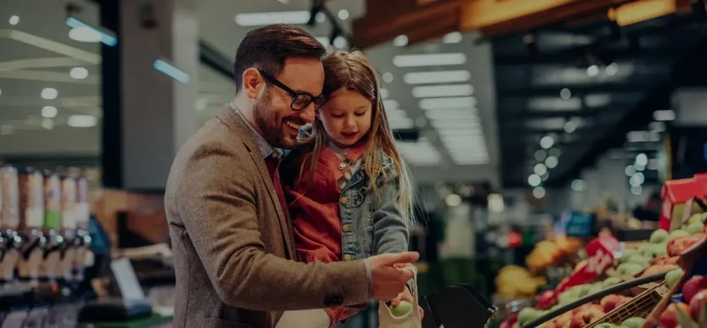 Father and his cute daughter buying fruits in super marker